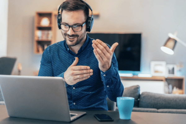 A remote worker wearing a headset, engaged in a VoIP call on his laptop, showcasing seamless communication with IT cloud services