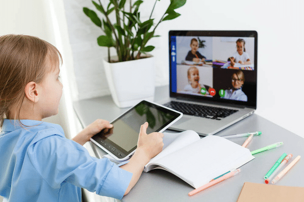 Student using a tablet for remote learning, supported by GO Technology Group’s managed IT services for schools, ensuring secure online access.