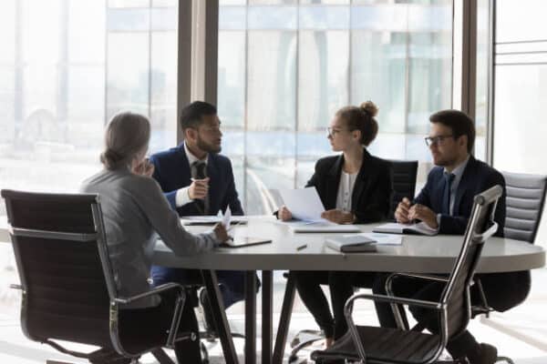 Team of legal professionals in a Chicago conference room discussing cybersecurity and IT services for law firms