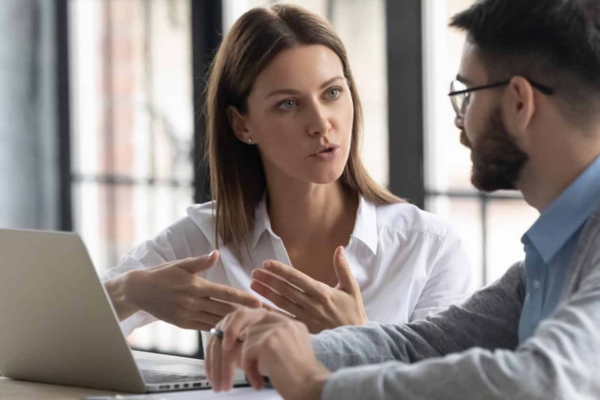 Which Resource Management Decisions Cut Costs or Increase Efficiency (1) IT consulting professionals discussing technology solutions in a modern Chicago office.