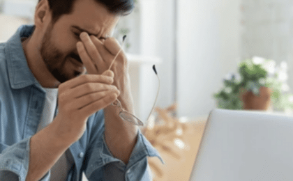 Frustrated man at laptop in Chicago office, representing the need for expert IT support services.
