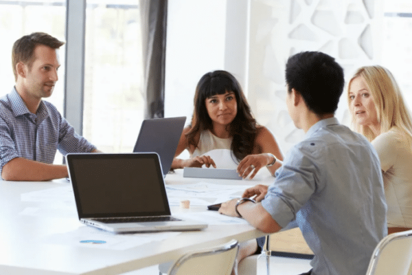 how to approach risk management in technology - 24 tips from a CTO Chicago IT consultant team discussing risk management strategies in a business meeting