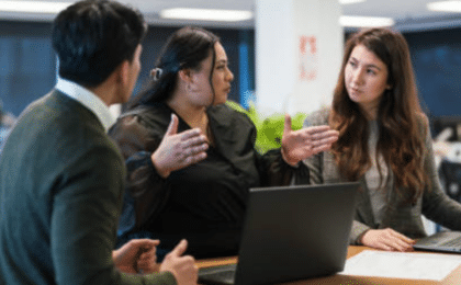 Professionals collaborating in a modern office environment as part of AI-driven digital transformation and workplace culture