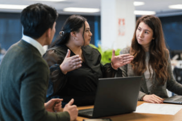 Professionals collaborating in a modern office environment as part of AI-driven digital transformation and workplace culture