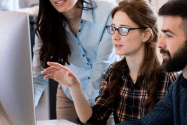 Employees collaborating during cybersecurity awareness training to reduce human risk and strengthen organizational security