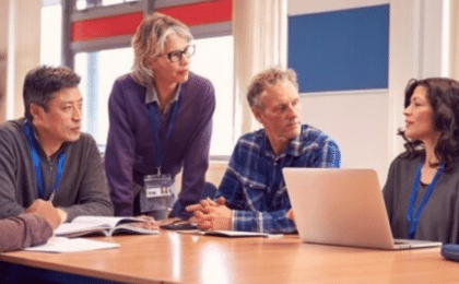 School leadership team collaborating on a school technology plan during a technology change discussion