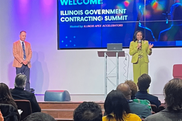 Speaker presenting at Illinois Government Contracting Summit on public sector IT and outsourcing strategies