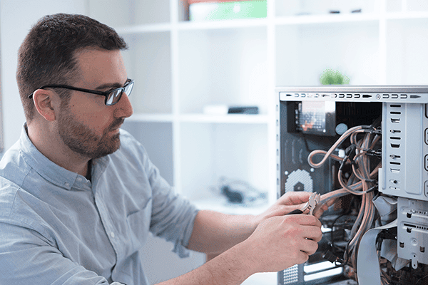 IT technician repairing computer hardware and supporting small business IT infrastructure and network systems