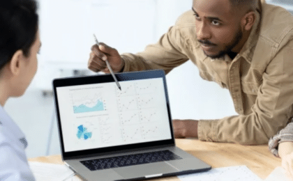 Business professionals reviewing workflow data and business process automation metrics during a team planning meeting