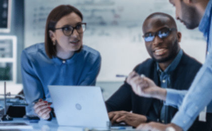 Business leaders discussing a digital transformation strategy involving cloud technology, cybersecurity, AI adoption, and operational modernization