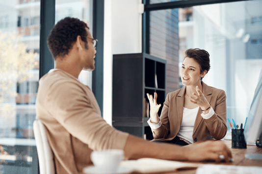 IT consultant advising a small business owner on proactive IT solutions