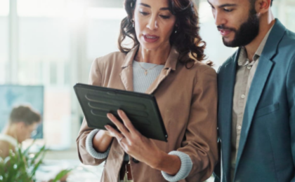 Business professionals reviewing business workflow management strategies to improve operational efficiency and modernize organizational processes