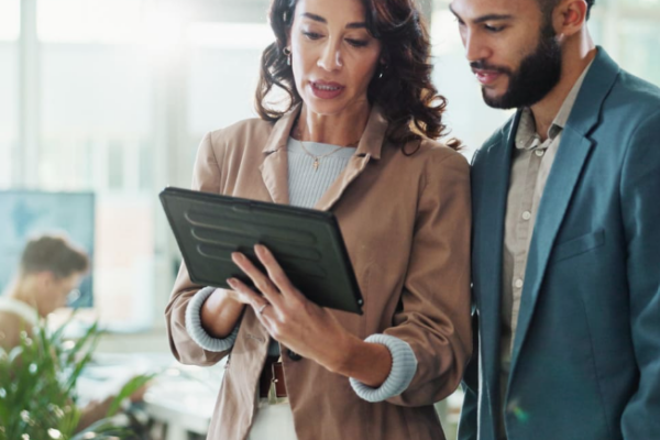 Business professionals reviewing business workflow management strategies to improve operational efficiency and modernize organizational processes